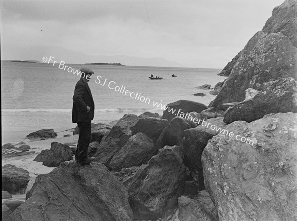 FISHERMAN WATCHING BOATS AT KEEM